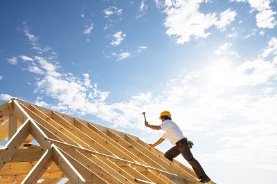 Man constructing roof